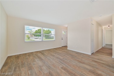 Spare room with light wood-style floors and basebo