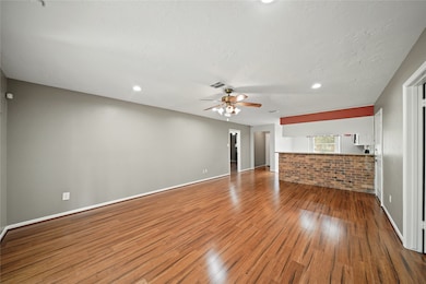 This spacious living area features hardwood vinyl
