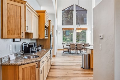 Kitchen featuring decorative light fixtures, stone
