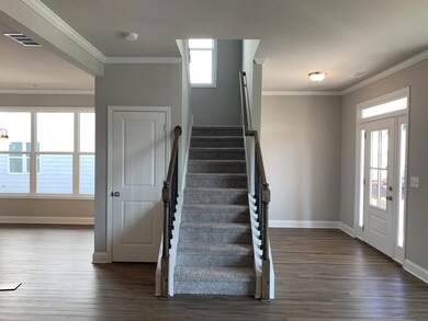 Staircase featuring wood finished floors, visible 