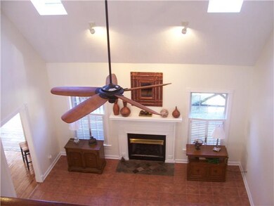 Stunning living room features skylights, porcelain