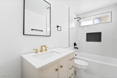 Full bathroom featuring vanity, toilet, and  showe