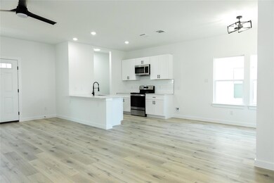 Kitchen featuring kitchen peninsula, stainless ste
