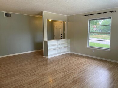 Spare room featuring crown molding, a textured ce