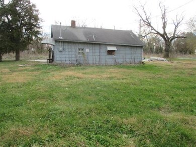 Rear view of house with a lawn and a chimney