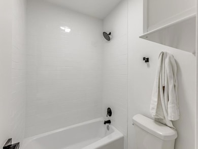 Full bath featuring shower / bath combination and