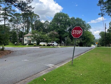 View of asphalt road featuring traffic signs and curbs