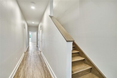 Stairs with wood finished floors and recessed ligh