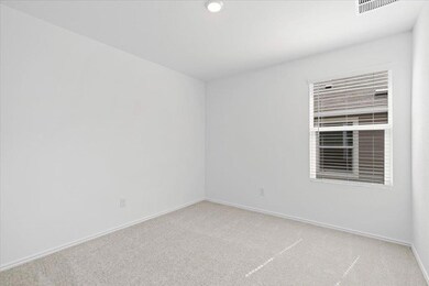 Spare room with light carpet and baseboards