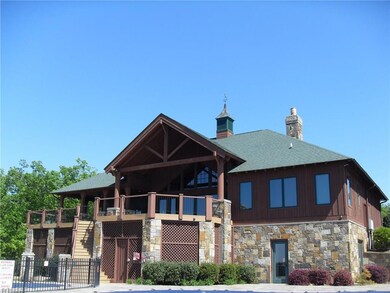 Back of clubhouse overlooking lake, pool & tennis courts