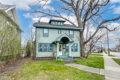 Traditional style home with a front yard, a chimney, and roof with shingles
