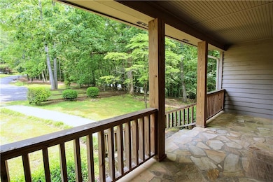 Covered porch featuring a lawn
