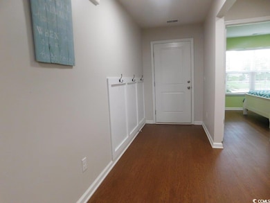 Corridor with dark wood finished floors and baseboards