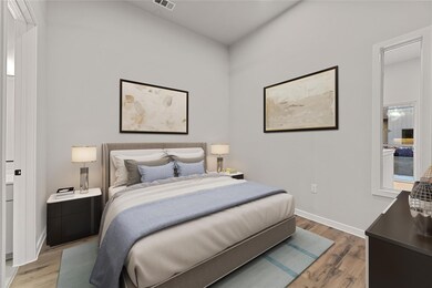 Bedroom with light wood finished floors and baseb