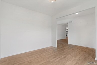 Empty room featuring light wood-style flooring and recessed lighting