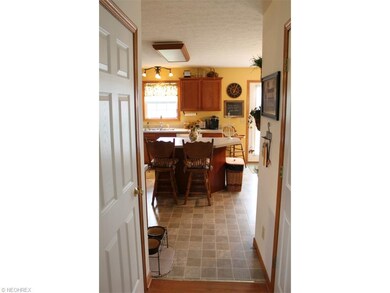Hall from foyer leads to kitchen at back of house.