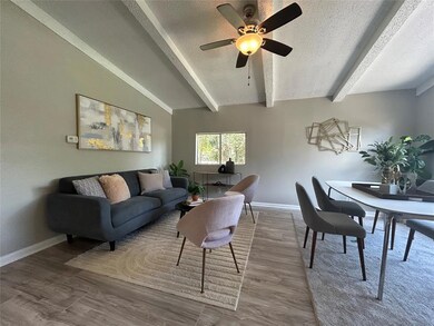 Living room with a textured ceiling, beam ceiling