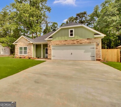Long driveway, privacy fence, 2 car garage, stone 