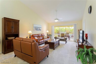Carpeted living room featuring high vaulted ceilin