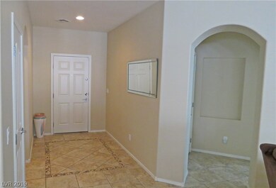 Front door to the left and arched entry is entranc