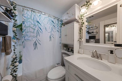Full bathroom featuring shower / bath combo and vanity