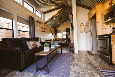 Living room featuring a wall mounted AC, wooden w