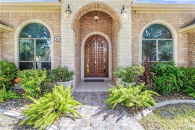 Property entrance featuring brick siding