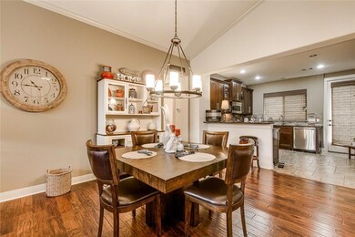 Dining area featuring vaulted ceiling, ornamental