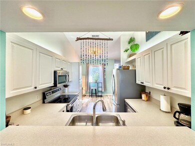 Kitchen with stainless steel appliances, sink, lig