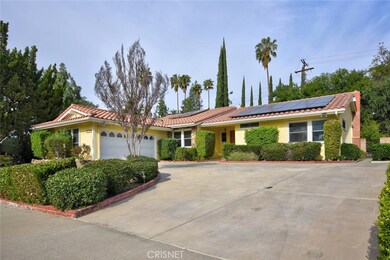 Wide concrete driveway, tile roof, solar system paid by seller, and dual pane windows throughout