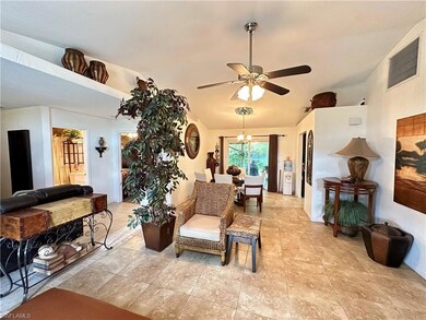 Living room with vaulted ceiling and ceiling fan