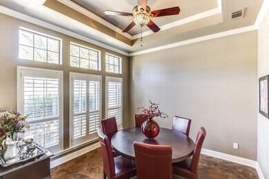 Dining space featuring ceiling fan, a tray ceiling