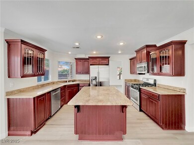 Kitchen with stainless steel appliances, a sink, l