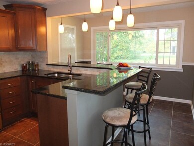 Breakfast bar and ceramic tile floor in remodeled 