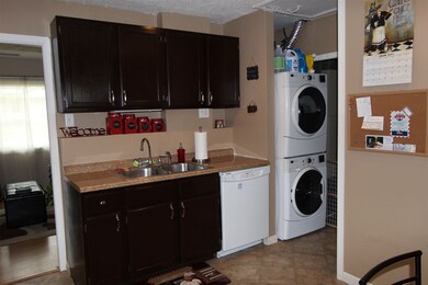 There is a utility room off the kitchen with addit