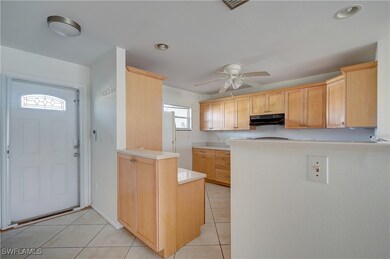 Kitchen with light brown cabinets, light tile patt