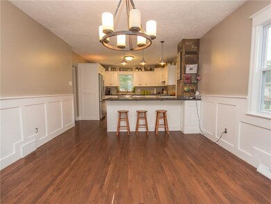 VIEW FROM END ON DINING ROOM TO OPEN KITCHEN WITH 