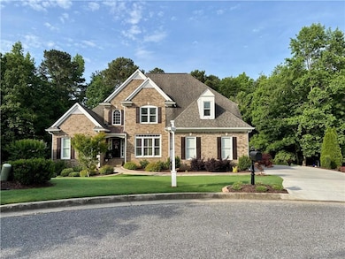 View of front facade with brick siding, a front ya