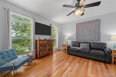 Living room featuring light wood finished floors and ceiling fan