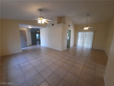 Empty room with a ceiling fan, light tile patterne