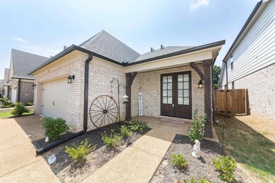 View of front facade with a garage and french door