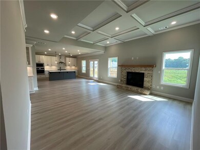 Unfurnished living room featuring light hardwood /