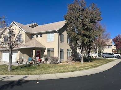Traditional-style home featuring roof with shingles, stucco siding, a porch, a front lawn, and a garage