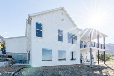 Back of house featuring a patio area, board and batten siding, and a mountain view