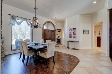 Tiled dining space with an inviting chandelier, a 