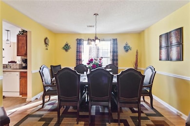 Dining space with a chandelier, wood-type flooring