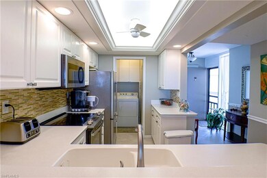 Kitchen featuring kitchen peninsula, sink, white c