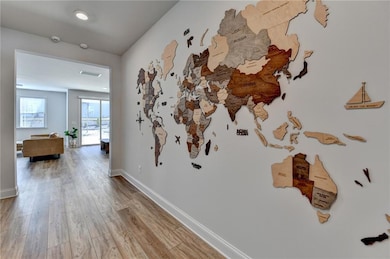 Corridor featuring baseboards, visible vents, and 