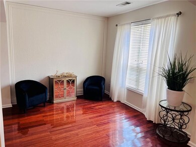 Formal living room with wood high grade finished floors, healthy amount of natural ligh