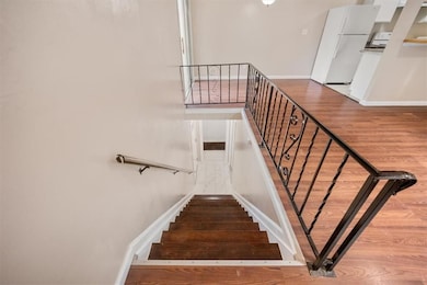 Stairway featuring wood finished floors and baseboards